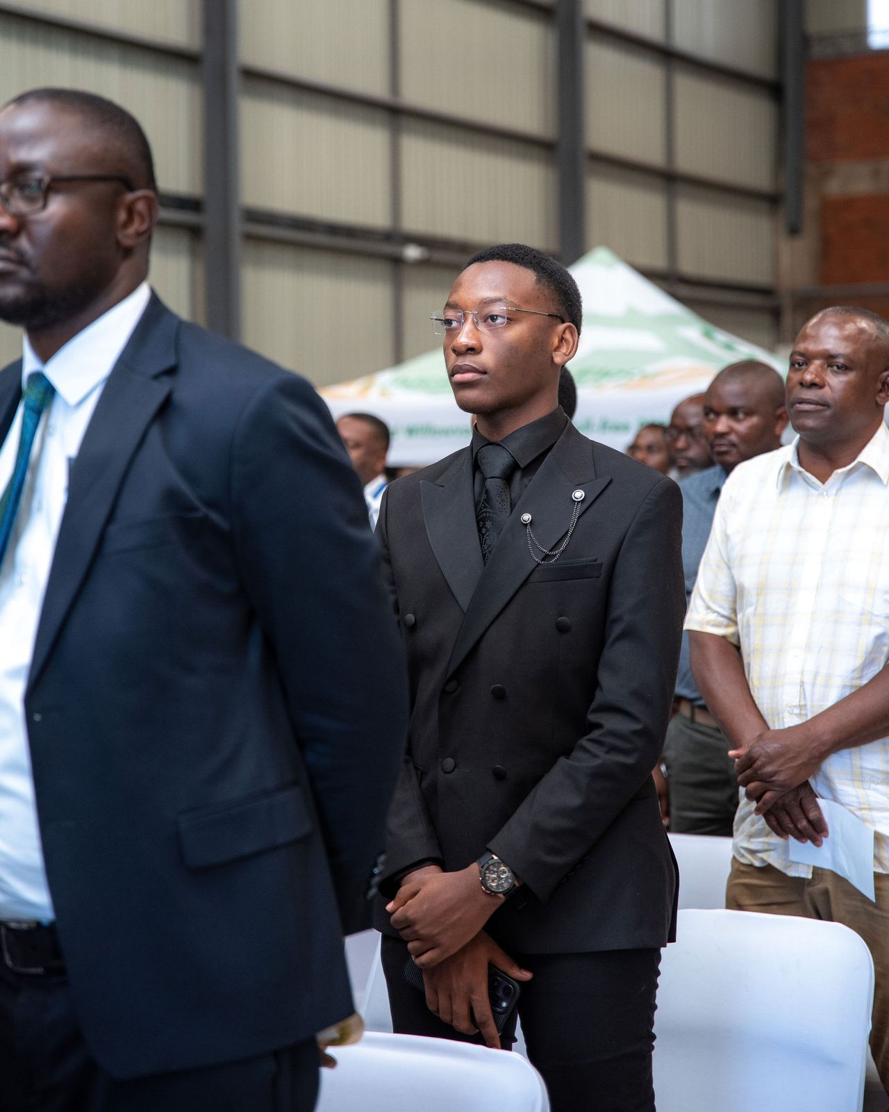 Guests standing between rows of chairs at an occasion on the sales floor