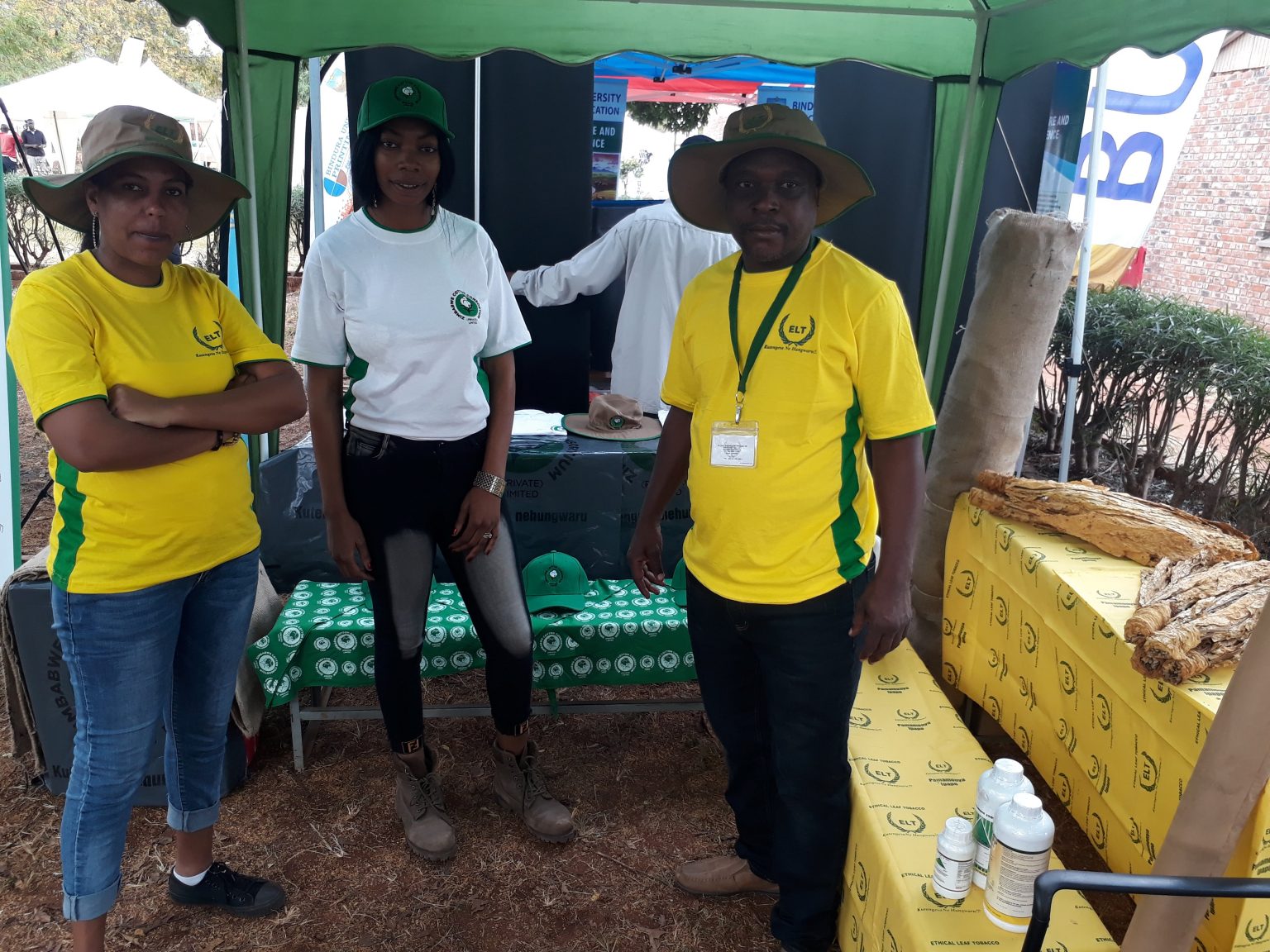 The ELT team at an agricultural expo, with cured leaf on display